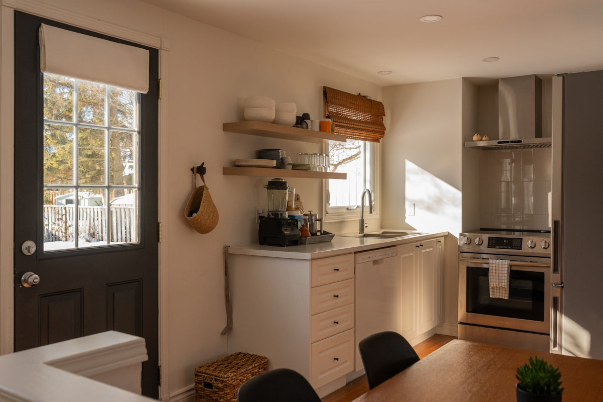 Modern kitchen with stainless steel appliances and wooden cabinets.