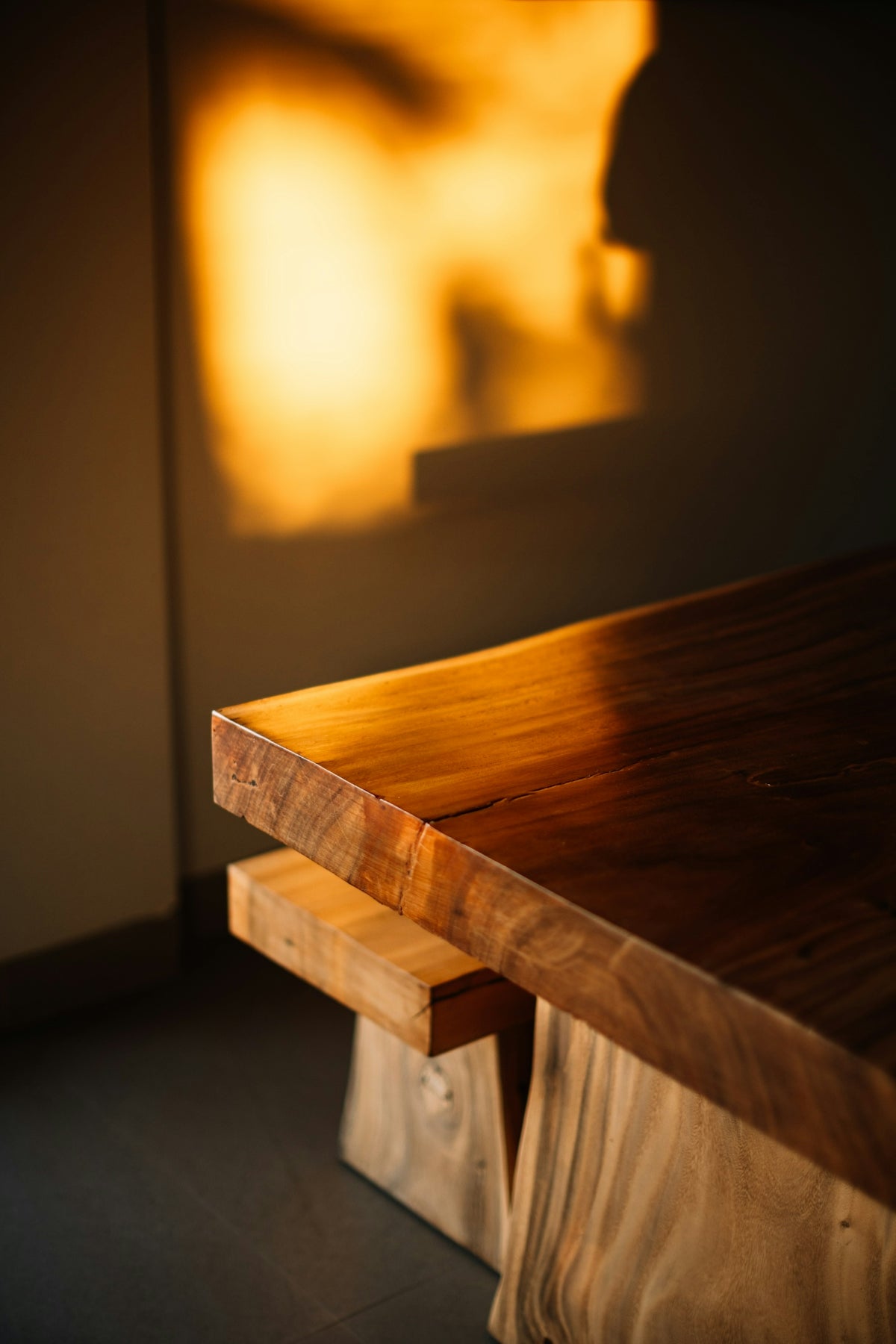 Live edge wooden table bathed in warm golden light.